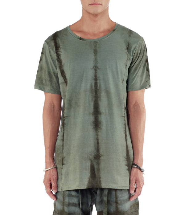 Men wearing a blue green T shirt made from organic cotton and hand dyed with plants.