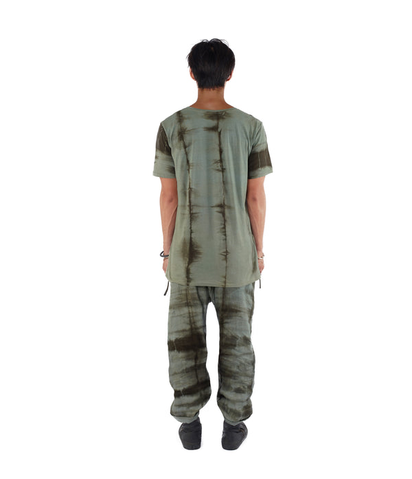 Men facing back, wearing a blue green T shirt dyed with plants.