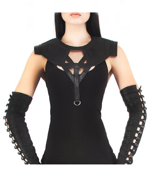 A person wearing a black leather collar with rounded ribbed shoulder detail and a diamond harness design.