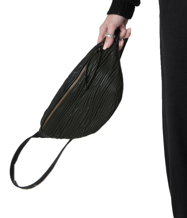 Compact, adjustable leather waist bag designed to carry a wallet, an iphone, a few miscellaneous items and some keys.